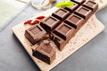 Dark chocolate on a white chopping board, light and bright colors
