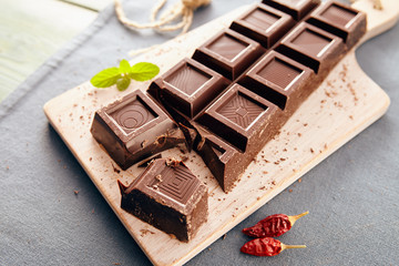 Dark chocolate on a white chopping board, light and bright colors