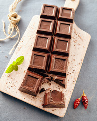 Dark chocolate on a white chopping board, light and bright colors