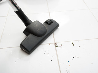 Vacuum cleaning dirt on a tiled floor