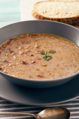 bean and spelt soup on a wooden table, bright colors