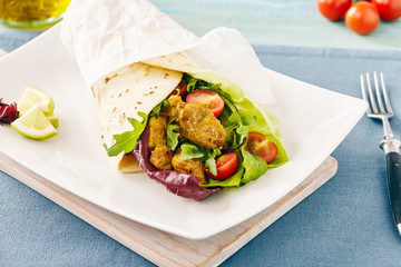 pork wraps on a white serving plate with rocket and lettuce, pastel colors