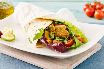 pork wraps on a white serving plate with rocket and lettuce, pastel colors