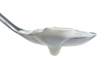 Spoon of milk cream isolated on white background