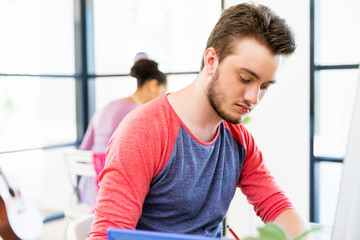 Fototapeta premium Young man working in office