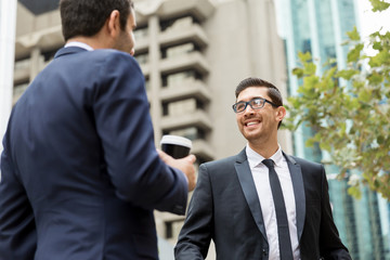 Two businessmen talking outdoors