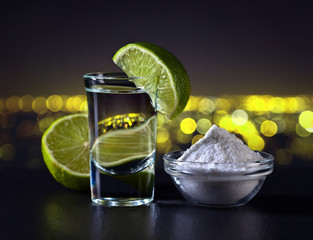Gold tequila on a background of night city