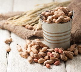 Peanuts on the wooden background,