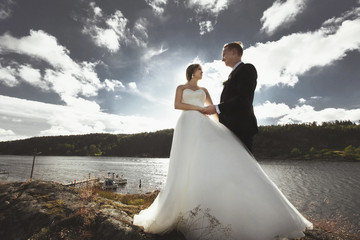 Bride and groom walking near the river