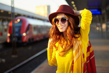 Pretty young woman at a train station (autumn toned image)