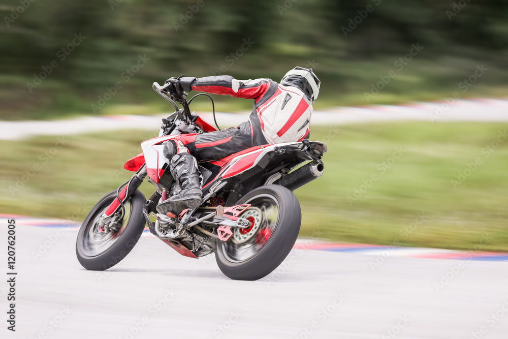 Wall mural motorcycle practice leaning into a fast corner on track