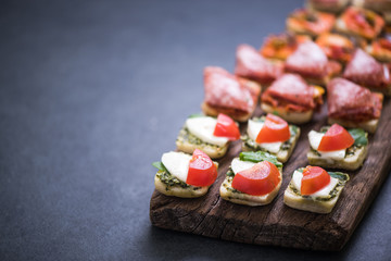spanish tapas on wooden board, selective focus