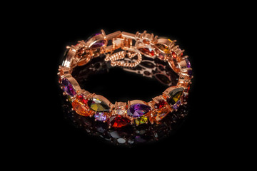 Bracelet with colorful stones isolated on black, close-up