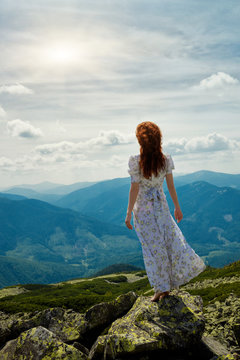 Happy woman enjoying the nature in the mountains