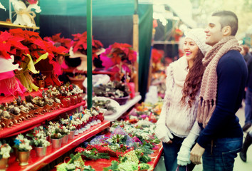 Couple buying Christmas flower at market