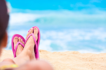 Girls feet relaxing on the beach. 