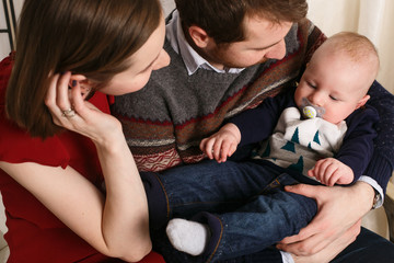 Joyful young family with a baby