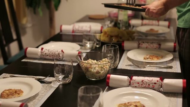 The owner of apartments serve a hot dish of pork.