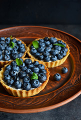 Tartlets with meringue and strawberries, festive table.
