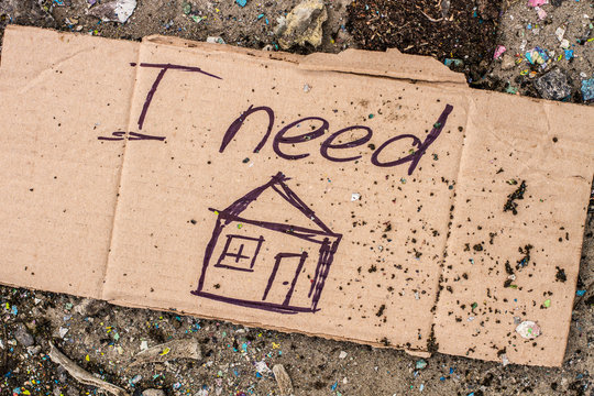 Sign of homeless man on cardboard