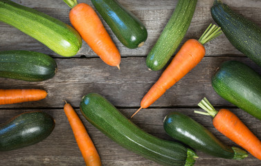 Fresh organic zucchini and carrot on the rustic table