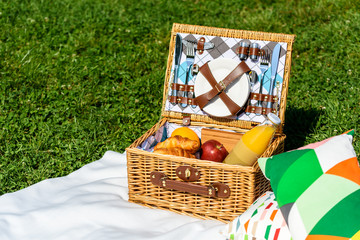 Picnic Basket Food On White Blanket With Pillows In Summer © radub85