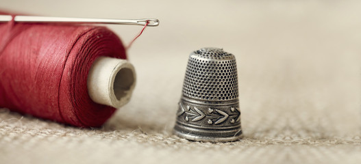 Old needle, thread and thimble - website banner of hobby, hand-made, DIY concept