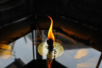 Detail of Burning Candle in Thai Buddhist Monastery