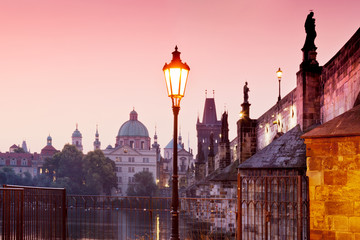Fototapeta premium romantic red sunrise over Moldau river, Charles bridge, Old Town Bridge Tower (UNESCO), Old Town, Prague, Czech Republic 