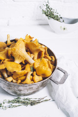 Chanterelles on vintage white wooden background top view, healthy food on table mockup, orange mushrooms isolated on rustic country board, fresh forest nutrition mock up closeup, copy space for text