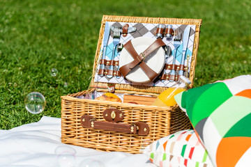 Picnic Basket Food On White Blanket With Pillows And Soap Bubbles