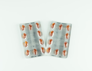 red pills in blister isolated on white background.
