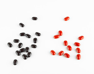 red and black Vitamin Pills isolated on white background.
