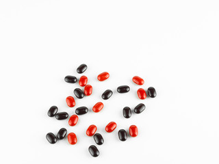 red and black Vitamin Pills isolated on white background.
