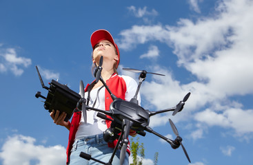 A woman is standing and holding drone. starting procedure