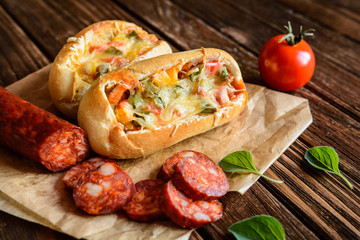 Bread boats filled with sausage, egg and cheese
