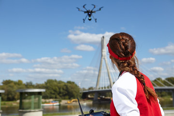 woman holding  drone uav over a field. Aerial video and photo
