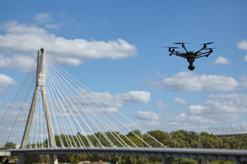 Copter flight against the blue sky. RC aerial drone.