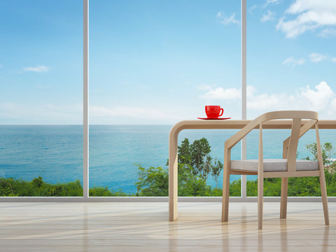 Sea view interior of home office with red coffee cup - 3d rendering