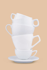 Vertical pile of many white coffee porcelain cups
