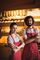 Obraz premium Portrait of couple standing with arms crossed