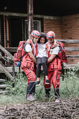 Rescue team evacuating victim from house