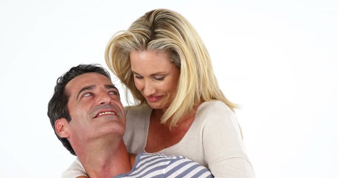 Happy man giving piggybag to woman against white background