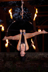 Aerialist on ring with palm torches