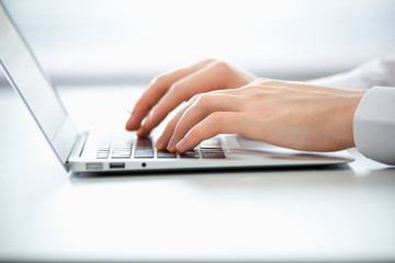 Close-up of hands of business man typing on a laptop.