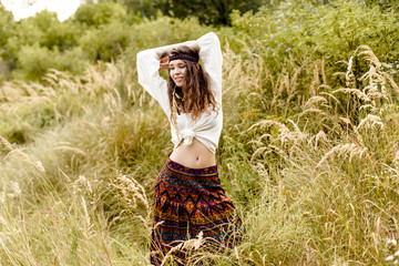 Young girl in ethnic clothes walking in fields. Fashion photo, folklore style