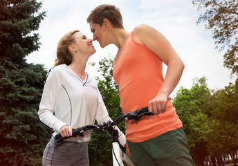 Happy couple kissing during a bicycle ride