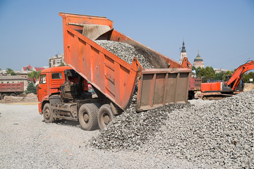 The truck empties gravel road construction