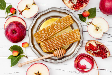 Apple, pomegranate and honey, traditional food of jewish New Year - Rosh Hashana. Copy space background