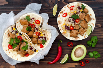 Mexican tacos with quinoa salad, meat, black beans and corn on rustic wooden table. Recipe for Cinco de Mayo party. Top view.